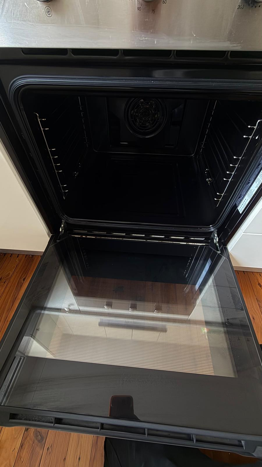 Open oven with its interior and glass door visible